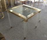 Acrylic legs corner table in brass color metal frame